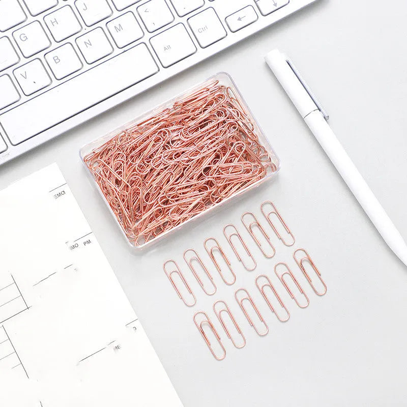 Rose gold heart-shaped metal paper clips, 28mm size, shown in a pack of 100.
