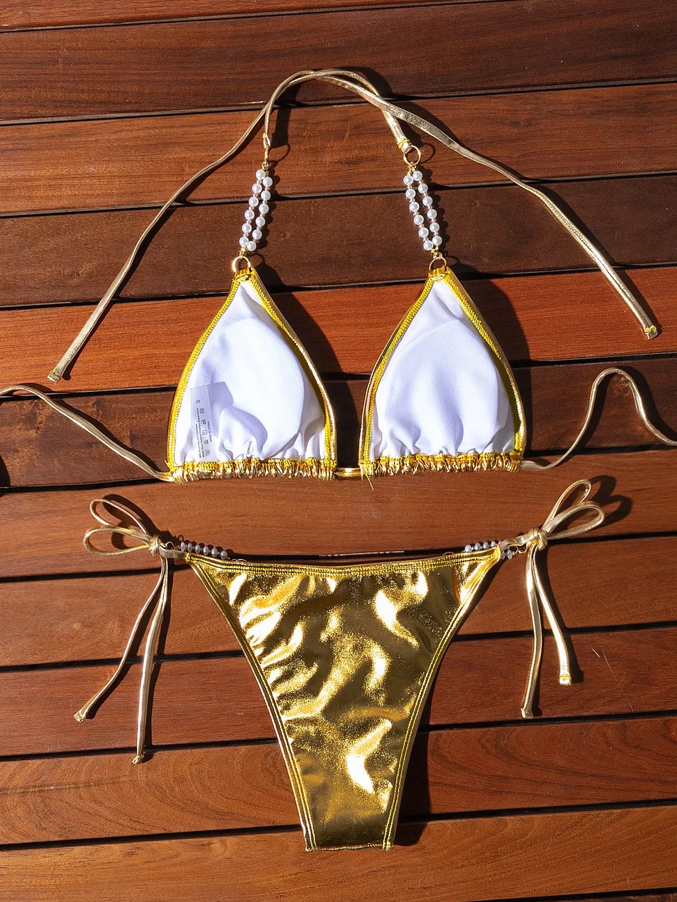Gold halter lace-up bikini swimsuit with pearl chain fastening on the back
