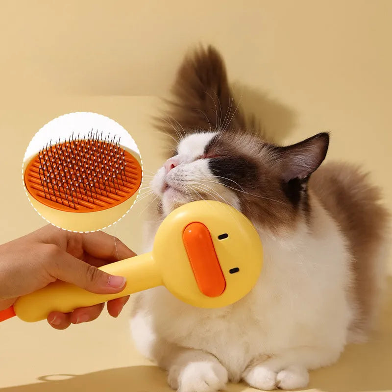 Small yellow duck-shaped pet grooming comb with open section design and needle teeth for cat and dog fur removal