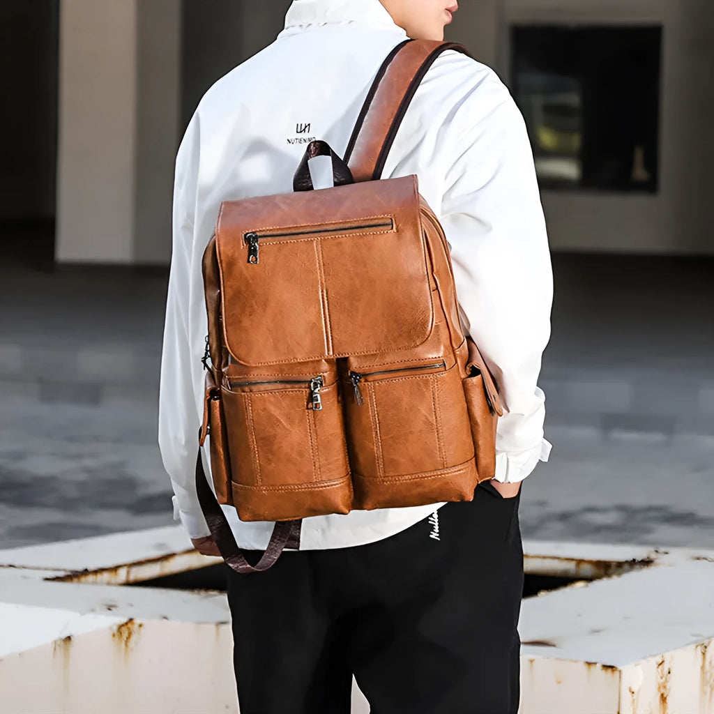 Vintage canvas backpack with sewing thread accents in brown, holding a 14-inch laptop