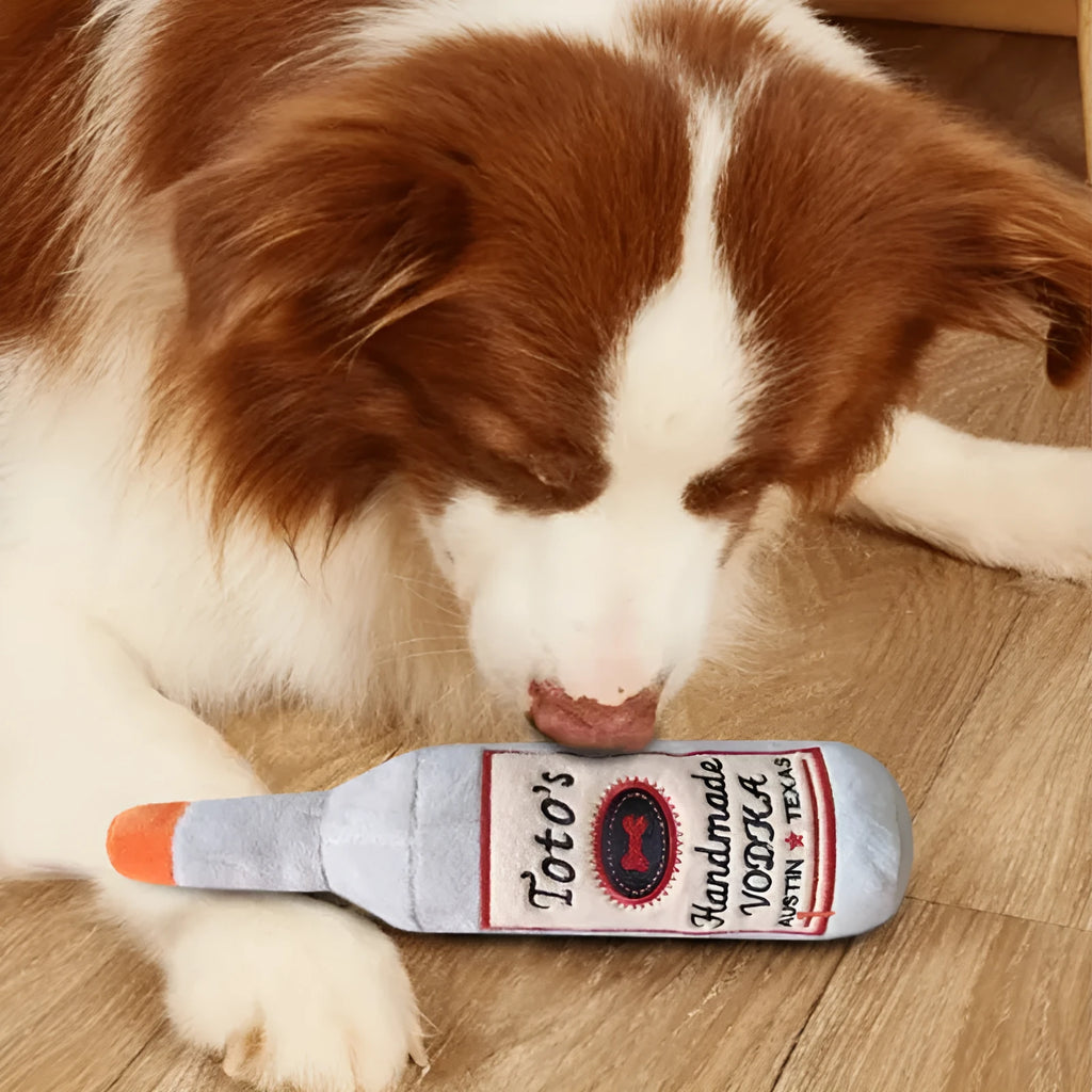 Brown plush dog toy shaped like a wine bottle with textured surfaces and a squeaker.