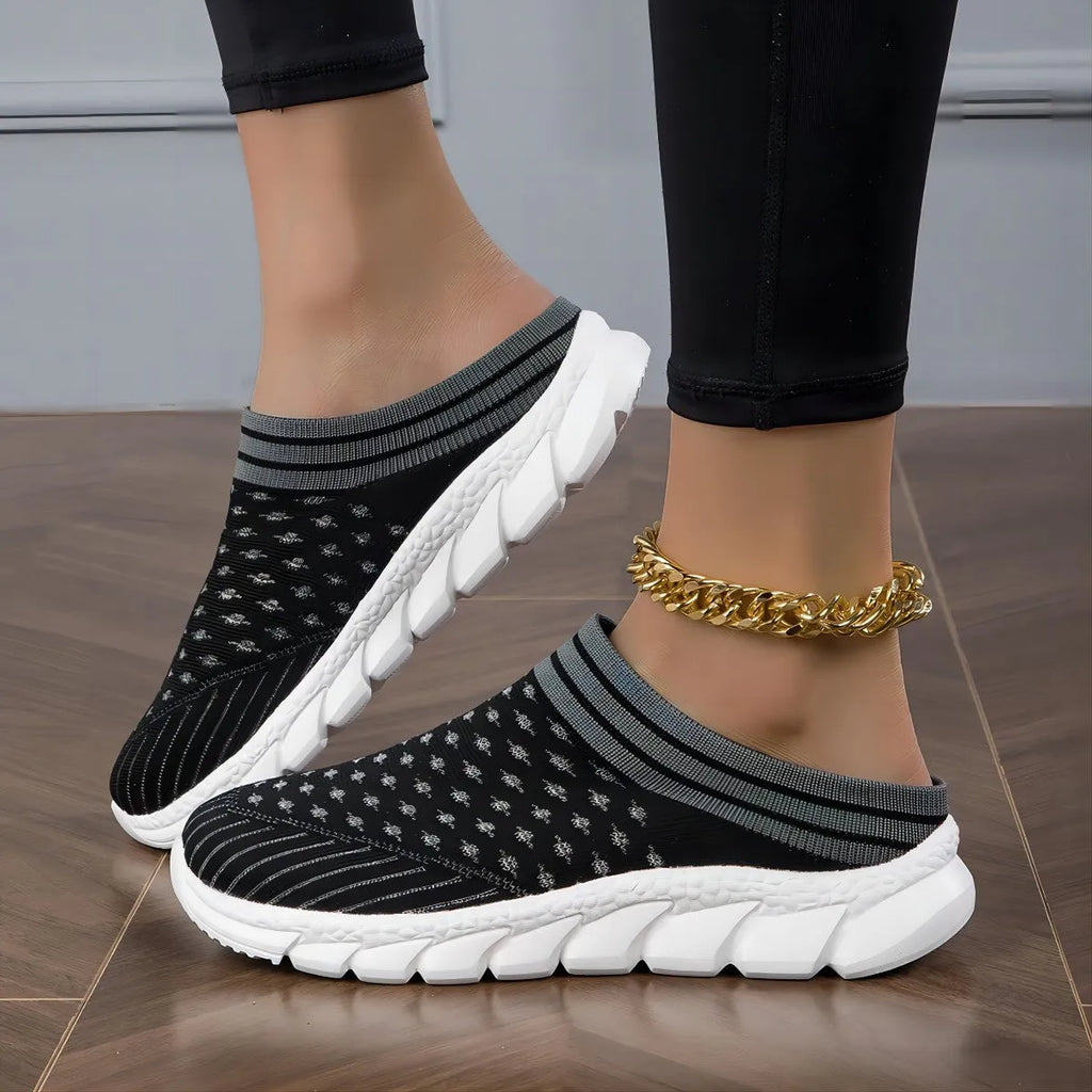 Women's black striped Flyknit slipper shoes with hollowed-out design on a viscose sole.