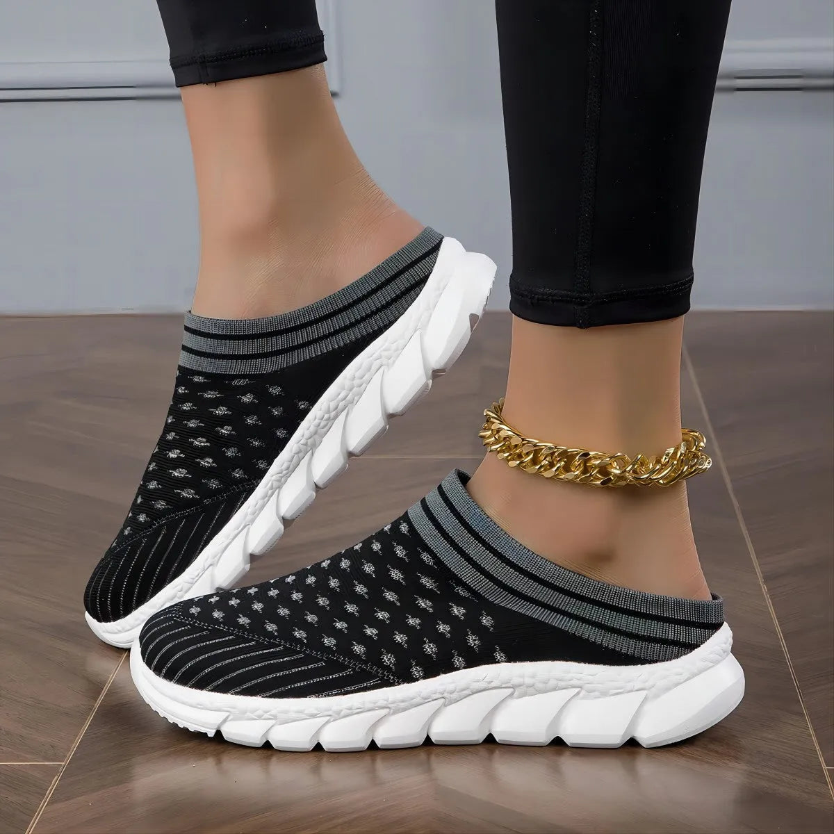 Women's black striped Flyknit slipper shoes with hollowed-out design on a viscose sole.