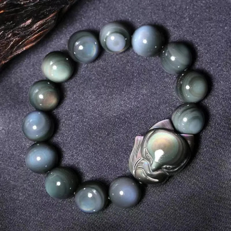 Obsidian stone bracelet with carved fox design on a central bead, shown in multiple size options.