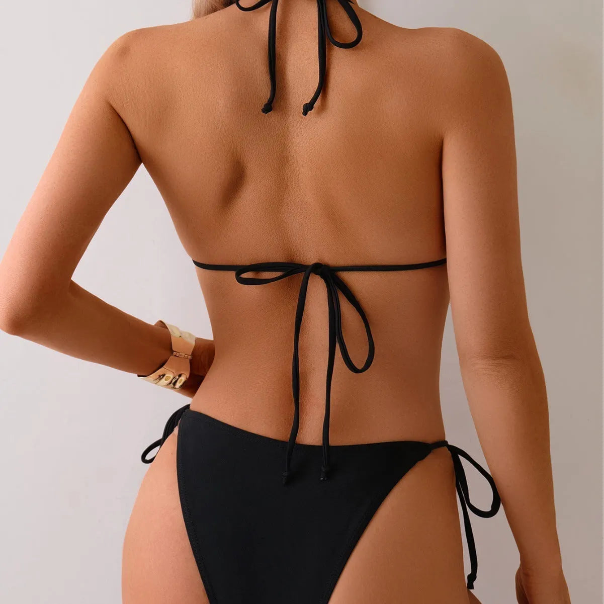 Black women's bikini swimsuit with metal bead decoration on the front.