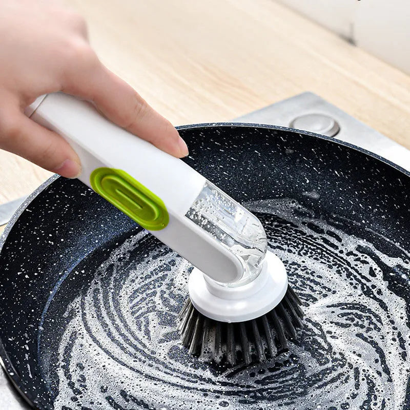 White and red long-handle kitchen brush with liquid dispenser button and two removable brush heads.