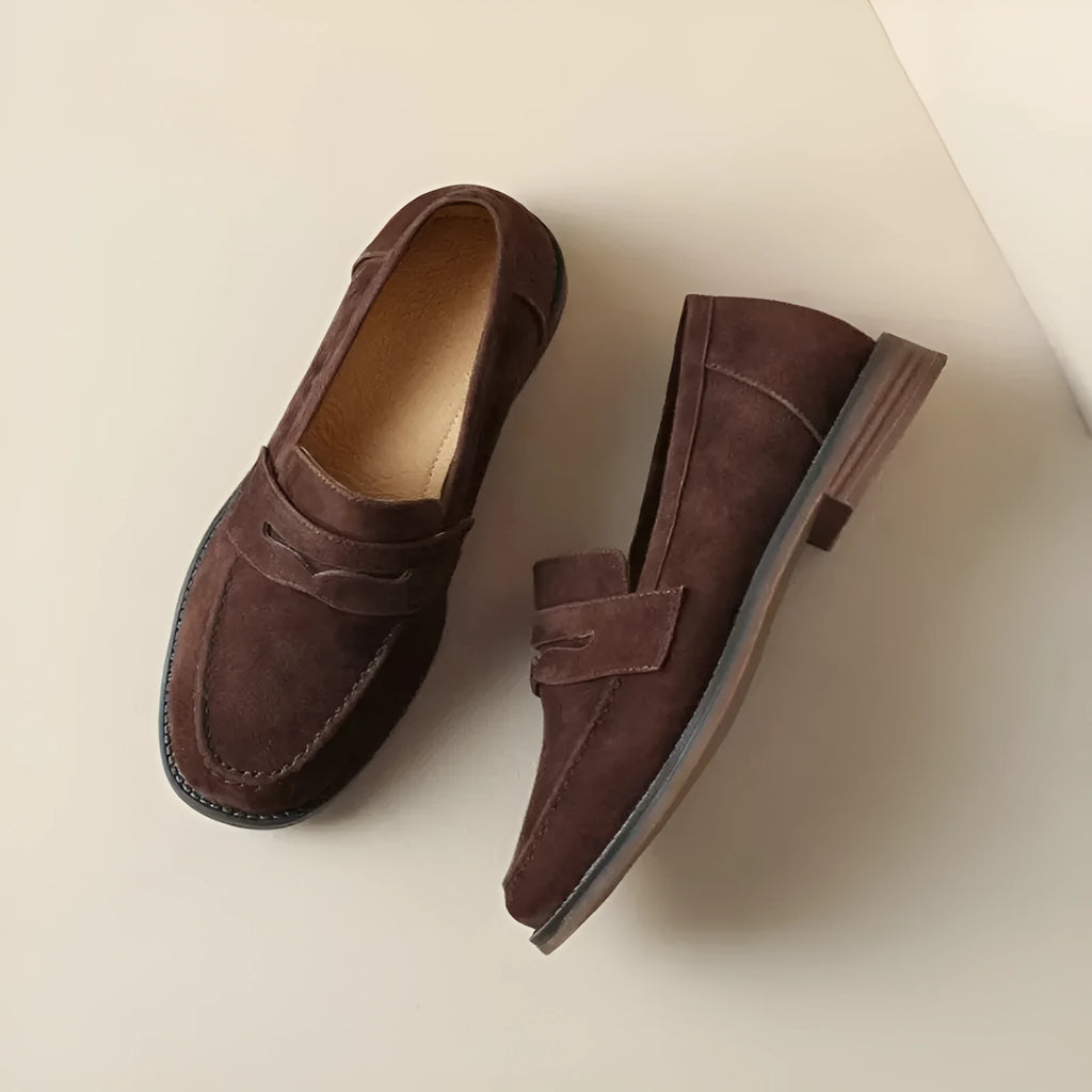 Women's suede leather flat loafers in black or brown, slip-on retro style with low heel under 3cm and top pigskin lining.