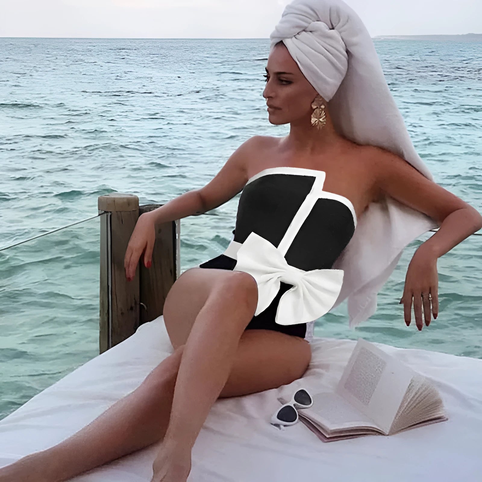 Black and white colour-block women's swimsuit with asymmetric tube top and bow detail