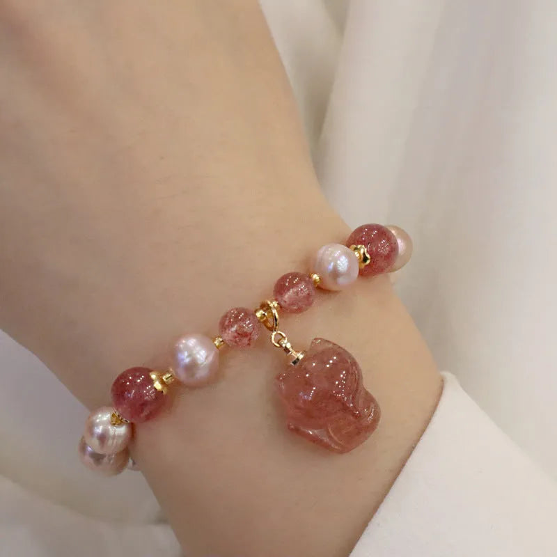 Women's light pink freshwater pearl bracelet with fox charm and strawberry quartz stones