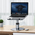 Silver aluminium car laptop stand with height adjustment and 360-degree rotating base on a car seat.