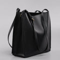 Brown genuine leather women's bucket bag with double shoulder straps and internal compartments.