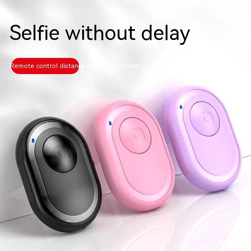 Small black wireless Bluetooth remote control for smartphone photography