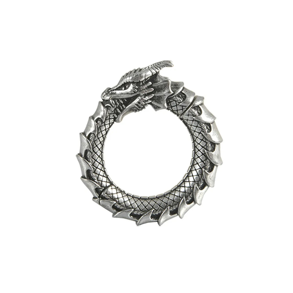 Large antique silver dragon-shaped earrings with hollow-out geometric design.