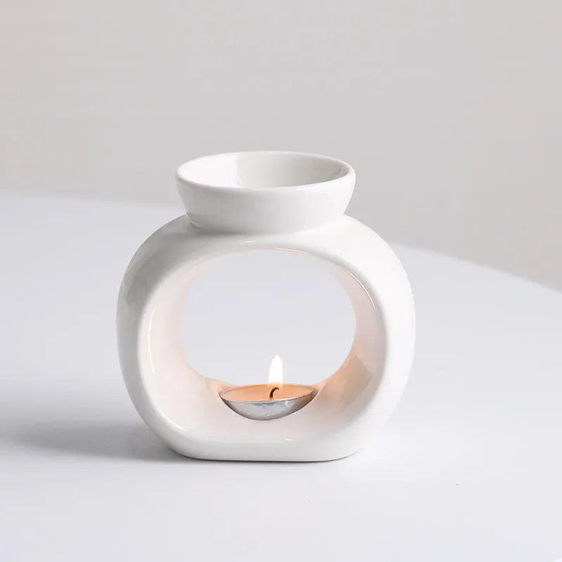 White Nordic style ceramic aromatherapy stove ornament on a wooden surface