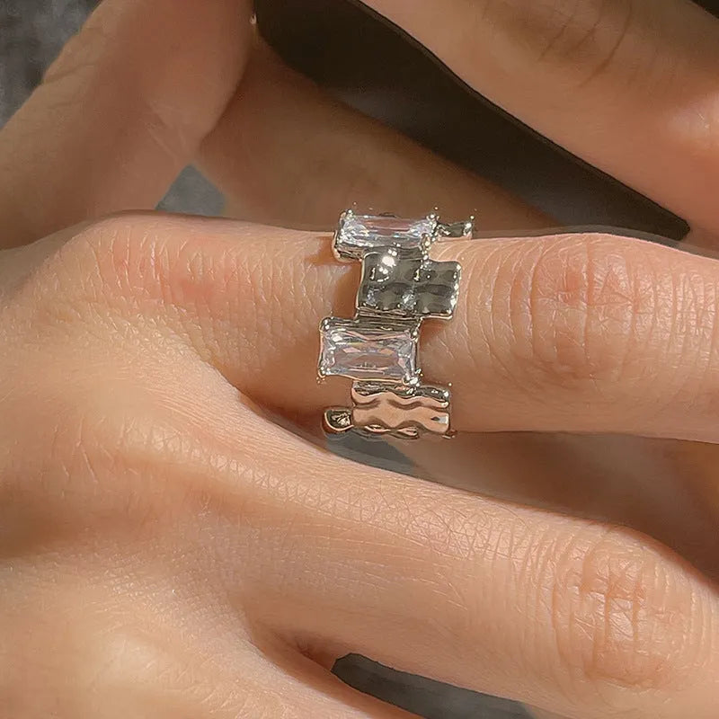 Silver geometric ring with cross zircon detailing and open gemstone setting
