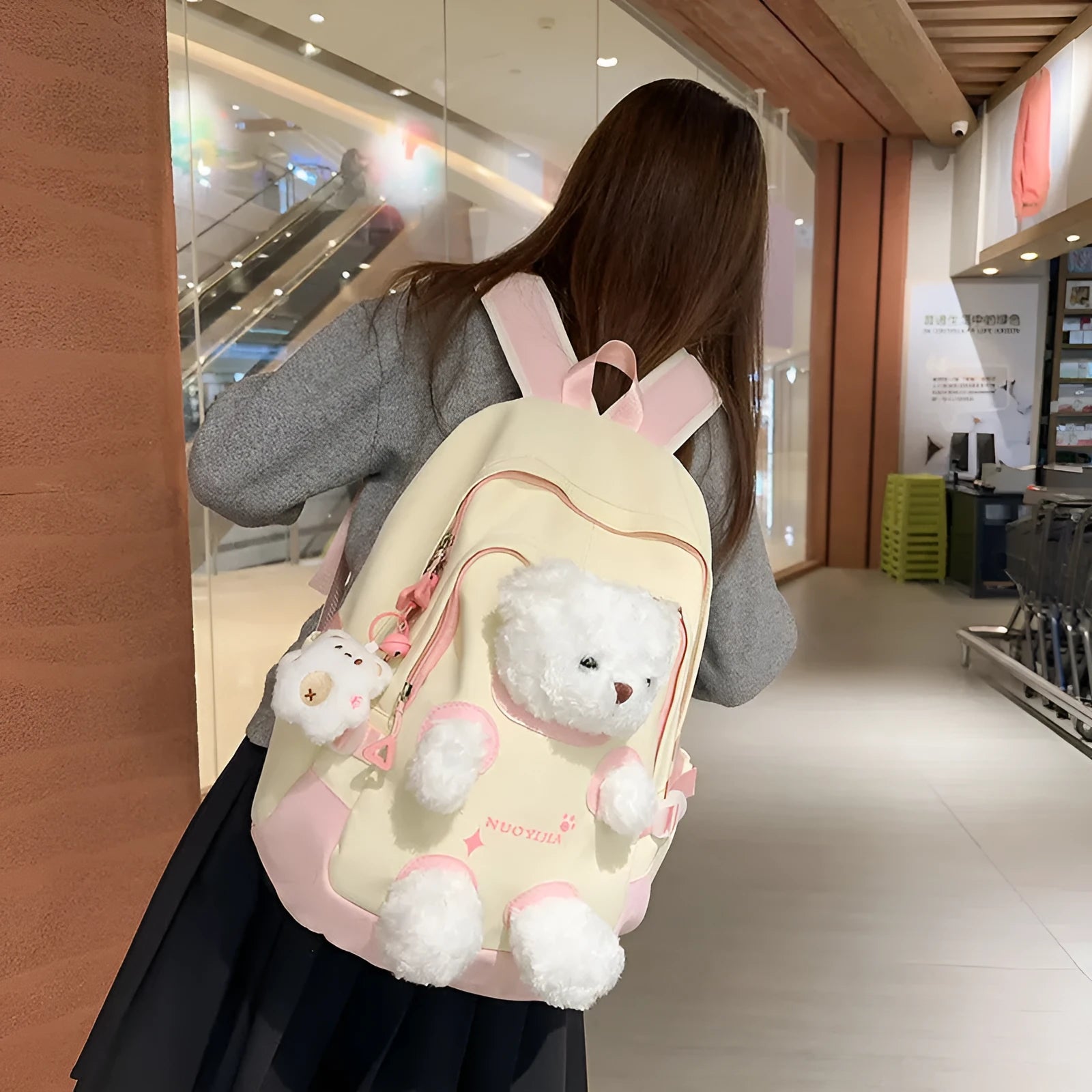 Nylon school backpack in a macaron colour with curved shoulder straps and sewing line detail.