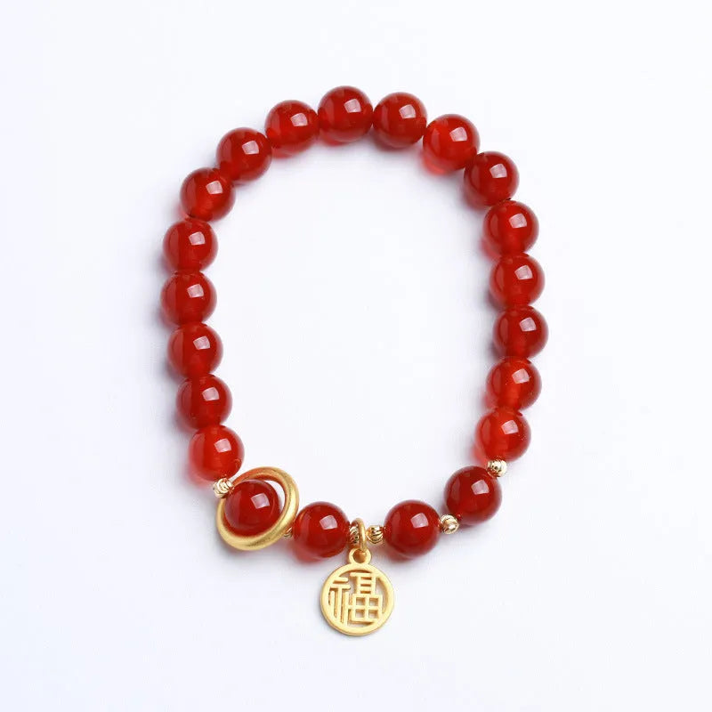 Natural red agate bead bracelet with woven design and blessing card on a neutral background.
