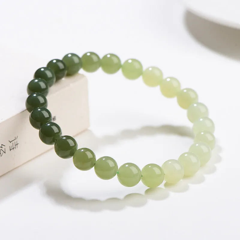 Natural clear water Hetian jade bracelet with gradient colour beads in round or barrel styles.