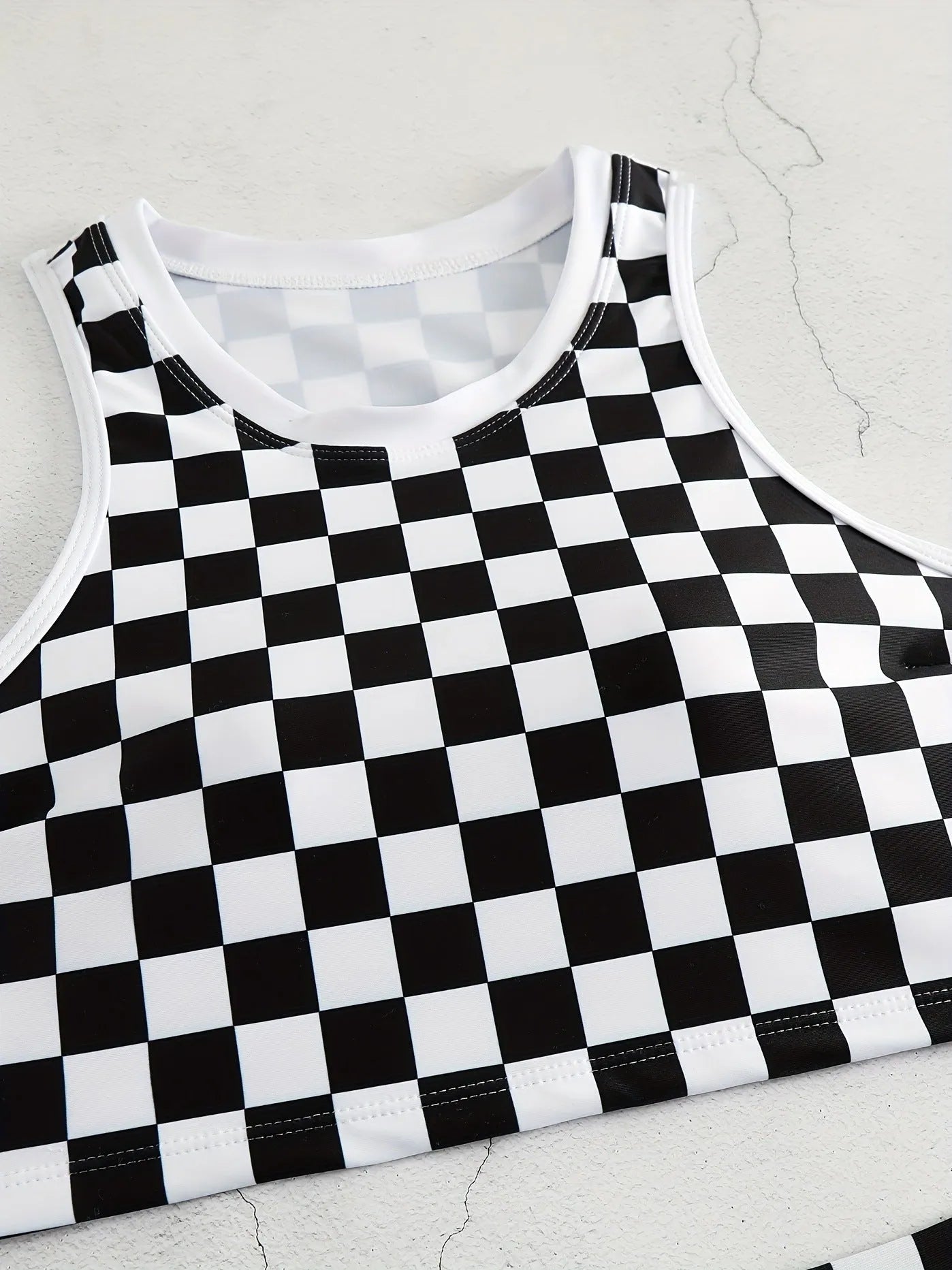 Women's checkerboard pattern racing one-piece swimsuit with backless design and suspender straps