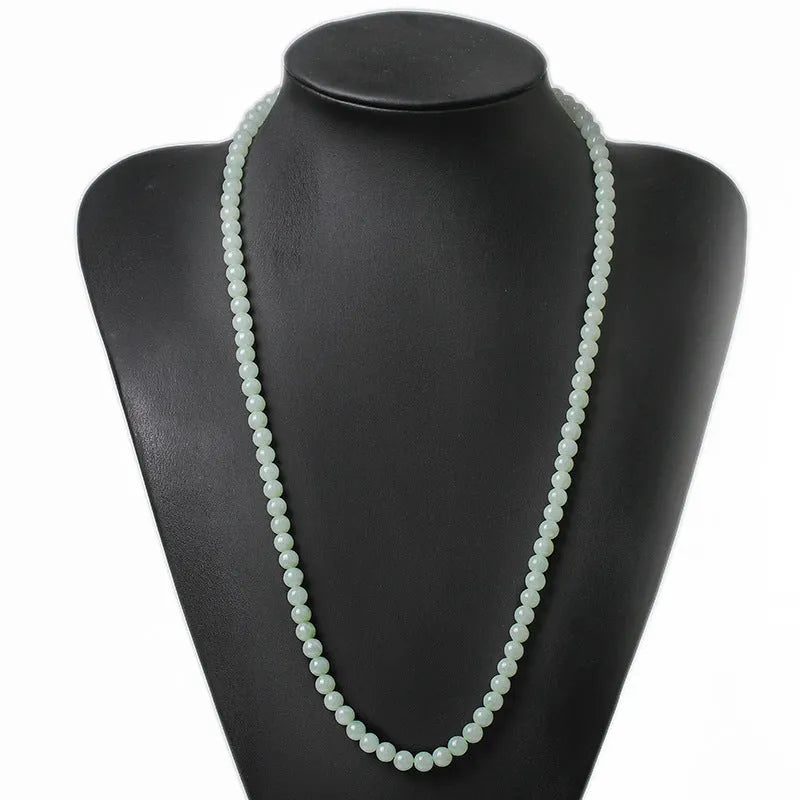 Adjustable length natural jade bead necklace with white and green round beads on a chain.