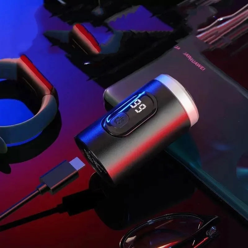 Black portable USB rechargeable shaver with LED display, shown with cleaning brush and cable.