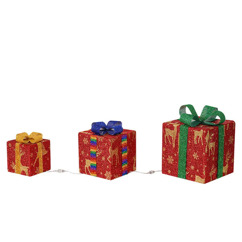 Set of three lighted Christmas gift box decorations with bows and LED lights for holiday displays
