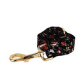 Dog wearing four-piece cloth accessory set with collar, leash, vest, and removable bow with lettering print