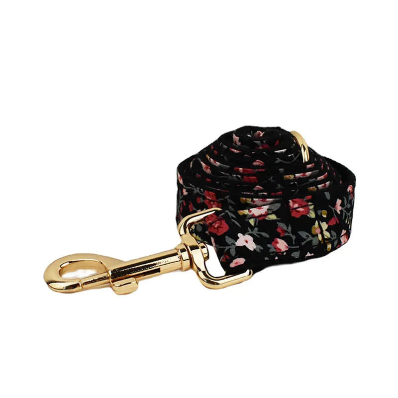 Dog wearing four-piece cloth accessory set with collar, leash, vest, and removable bow with lettering print