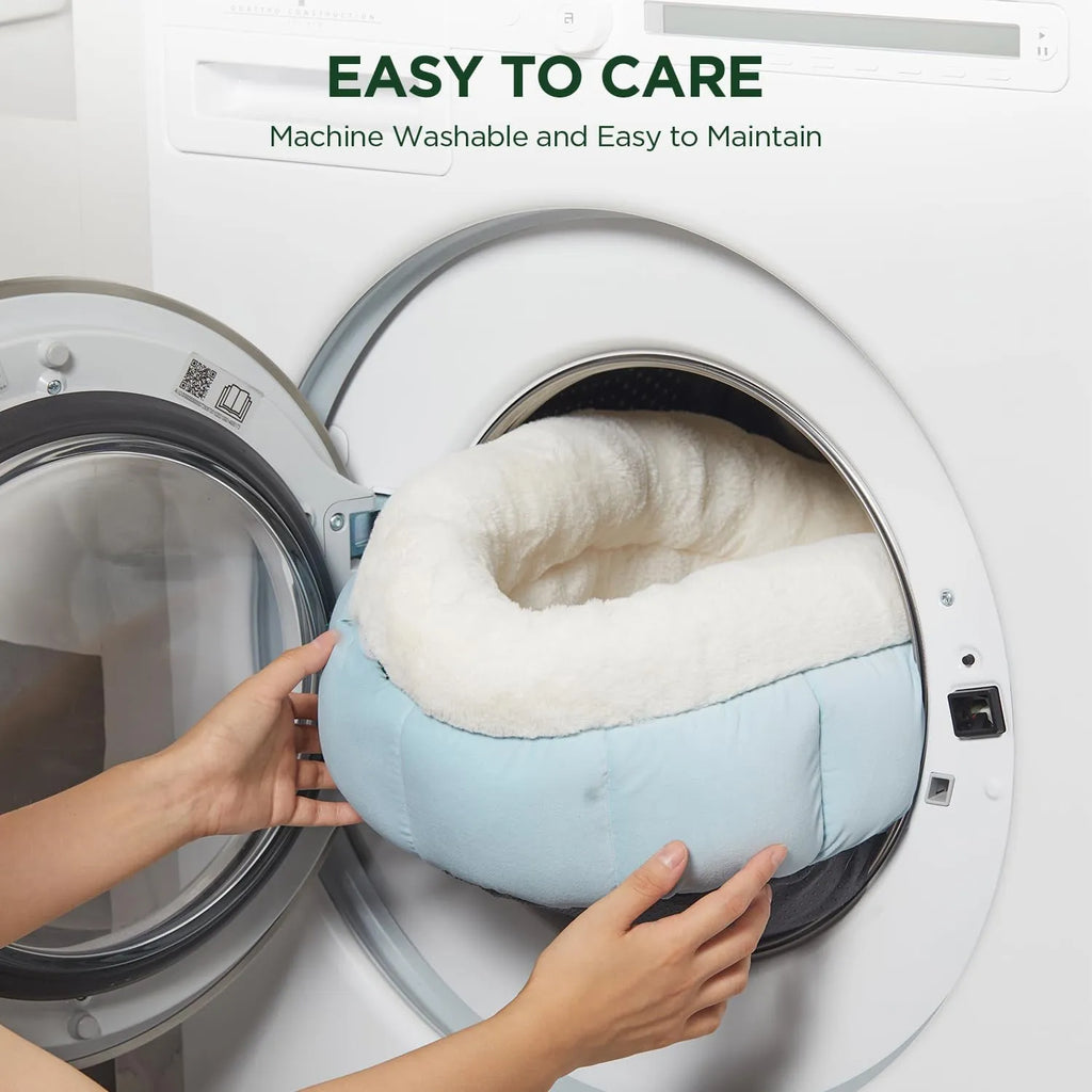 Round donut dog bed in faux rabbit fur with raised sides and anti-slip bottom, sizes XS to XL, colours blue brown green pink