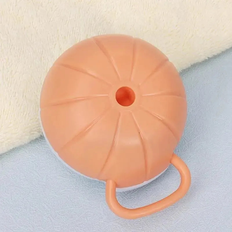 Orange TPR dog bath brush with shampoo dispenser and pumpkin-shaped grip for pet grooming