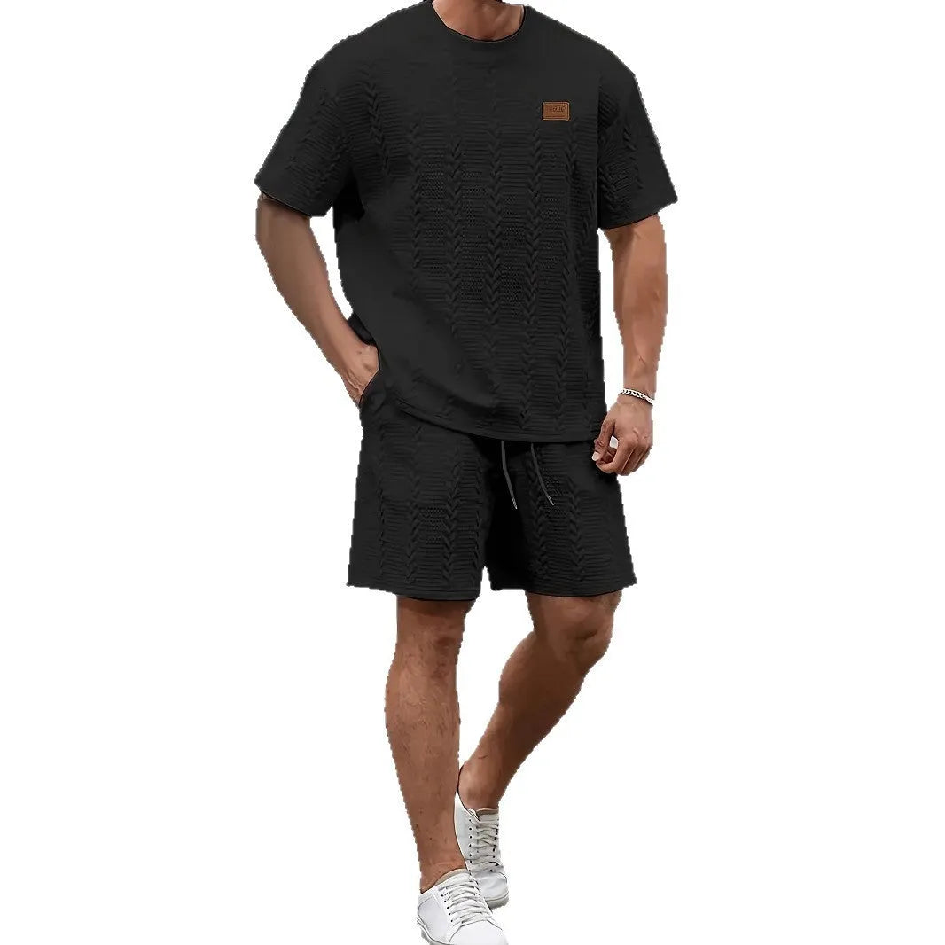 Men's black sports two-piece set with ribbed short sleeve top and matching shorts