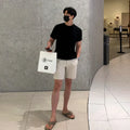 Men's straight leg casual shorts in non-ironing polyester fabric available in black, white, and khaki colours