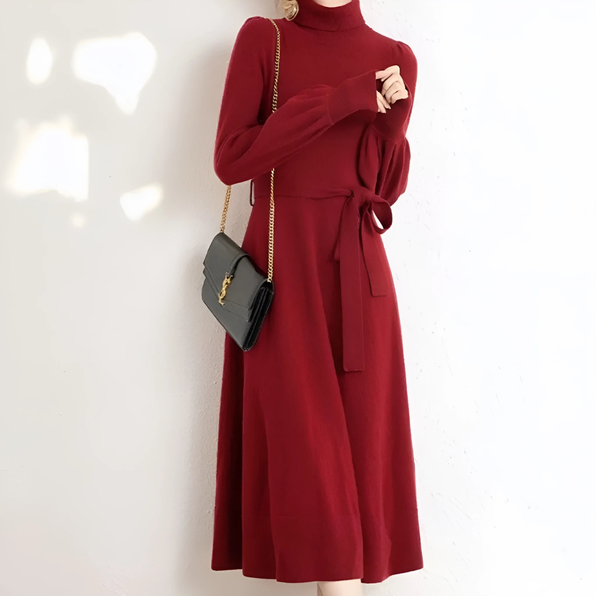 Women's rose red turtleneck knitted dress with long sleeves and a mid-length skirt.