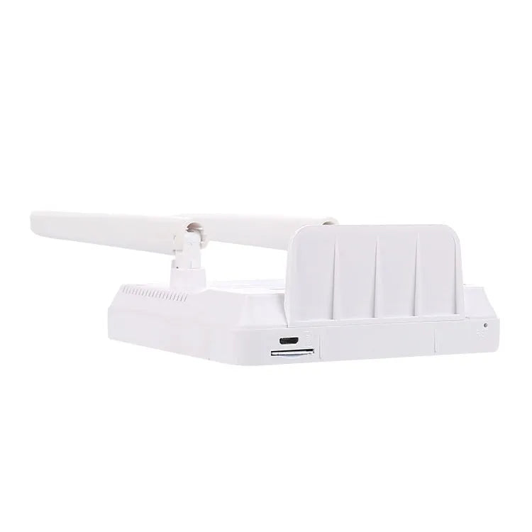 White LTE router for home office with two external black antennae connected, placed on a desk.