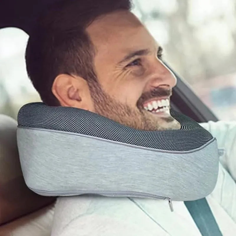 Navy blue U-shaped travel neck pillow with memory foam filling shown rolled for compact storage