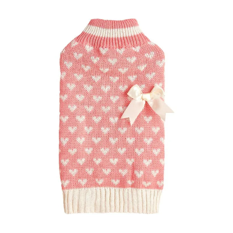 Red dog sweater with white love heart and bow design on a small dog