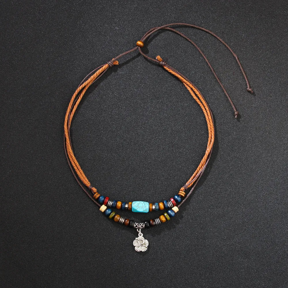 Men's retro necklace with geometric flower pendant and turquoise wooden beads on a wax rope chain.