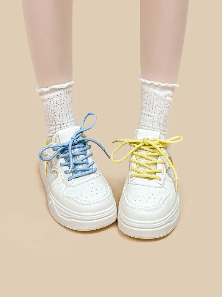Korean-style white and blue sneakers with mesh cross-straps and lace-up closure for children.