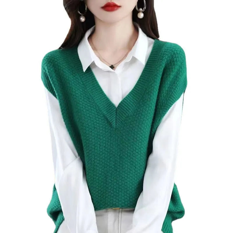 Creamy-white V-neck sleeveless knitted vest with a raised 3D pattern texture on a hanger.