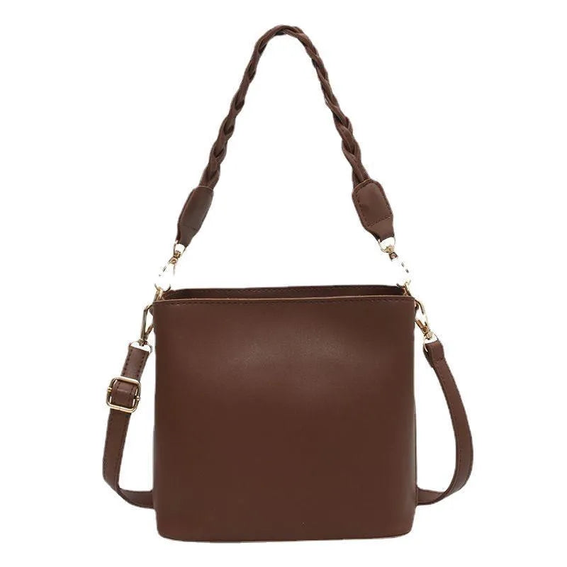 Retro khaki PU leather crossbody bucket bag with woven detail and a brown strap.