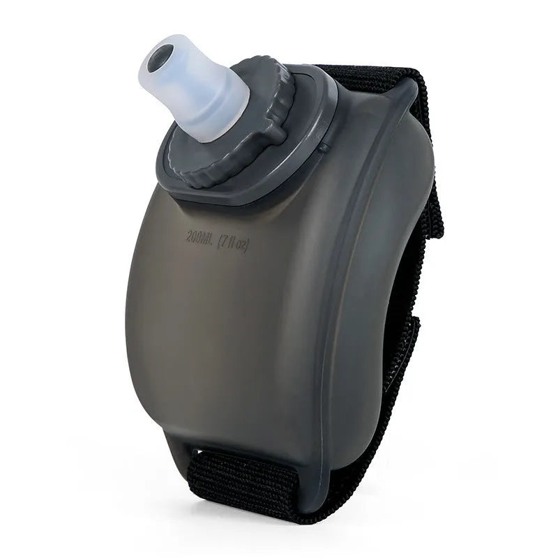 Black silicone wrist water bottle with adjustable Velcro strap shown on a wrist, 200ml capacity for sports.