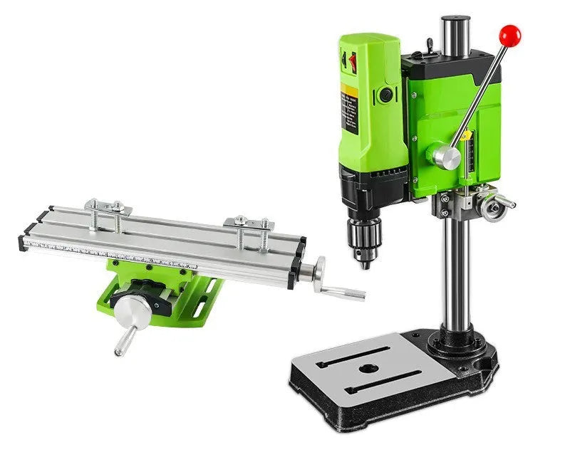 Mini bench drill and milling machine on a workbench with bench pliers.
