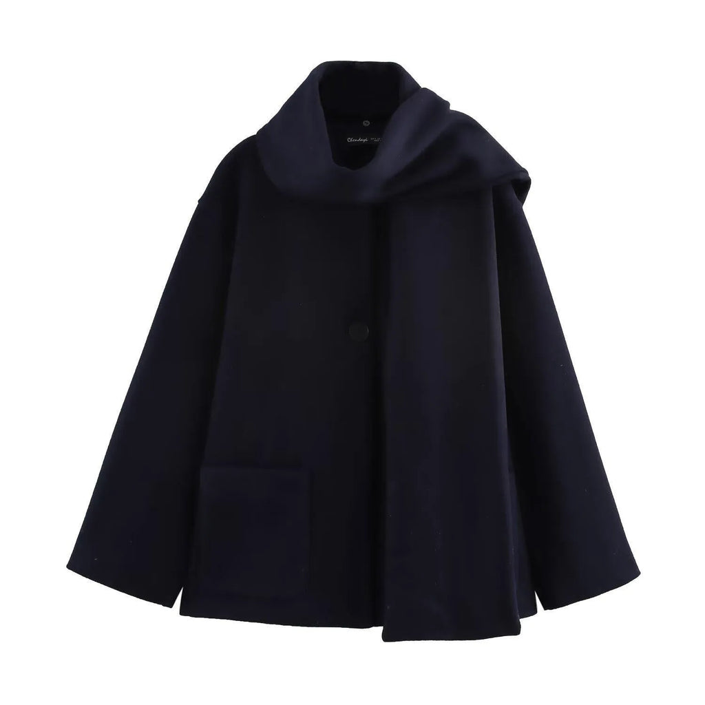 A woman wearing a longline black polyester coat with a detachable faux fur collar.