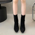 Brown square-toe kitten heel ankle boots with a side zipper on a white background.