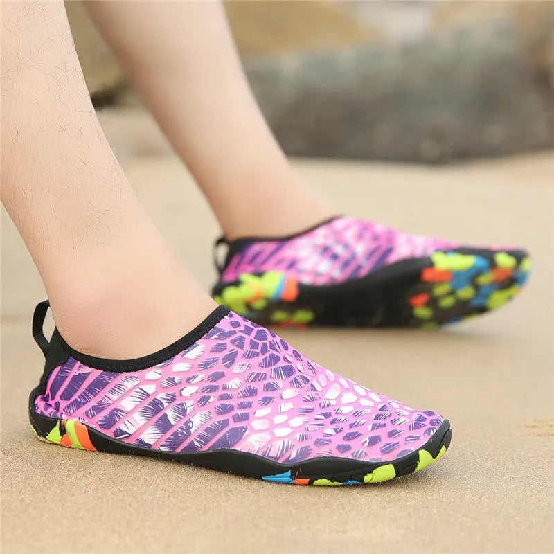 Lycra beach wading shoes with EVA midsole in blue, shown on a sandy shore.