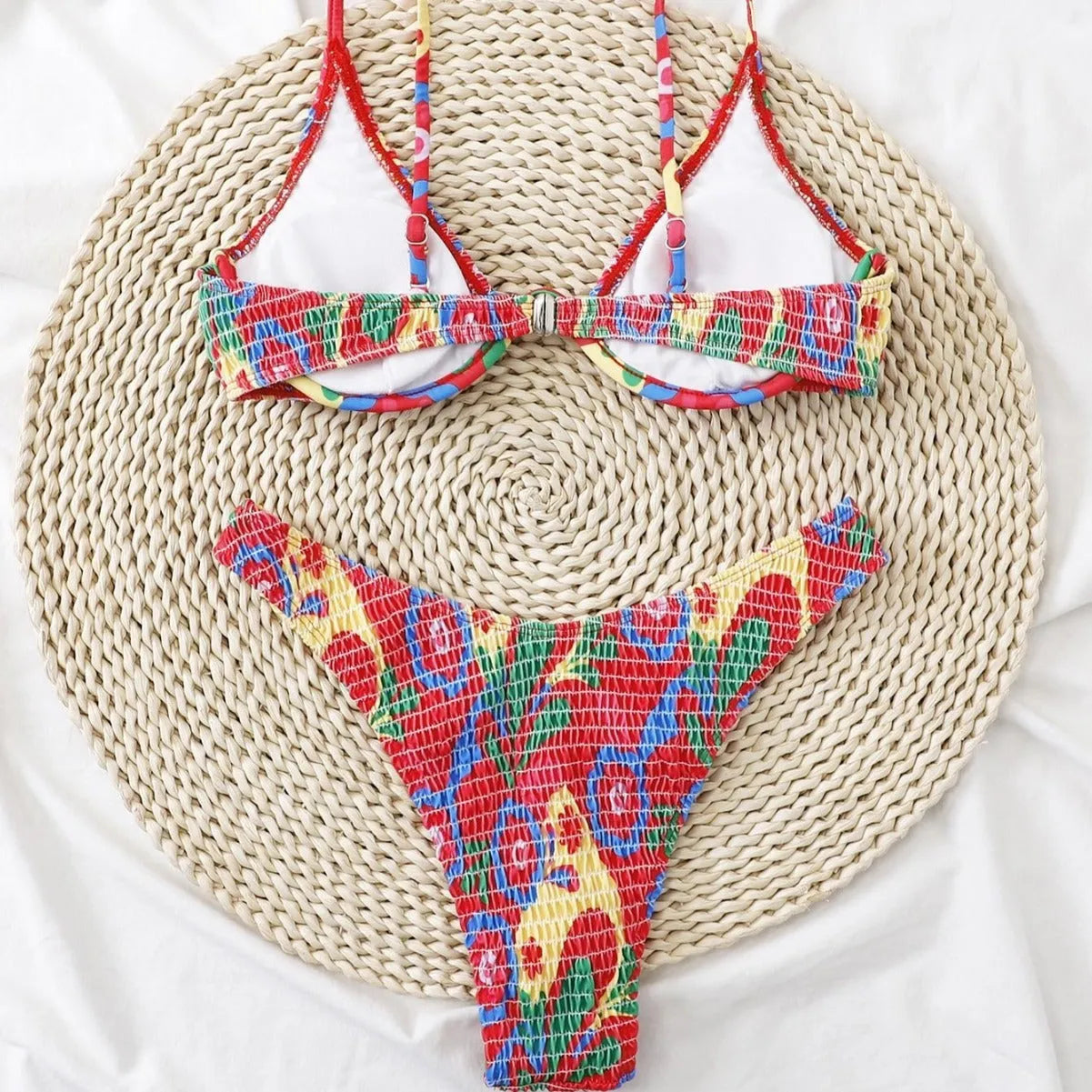 Red floral underwire bikini top and briefs on a white background.