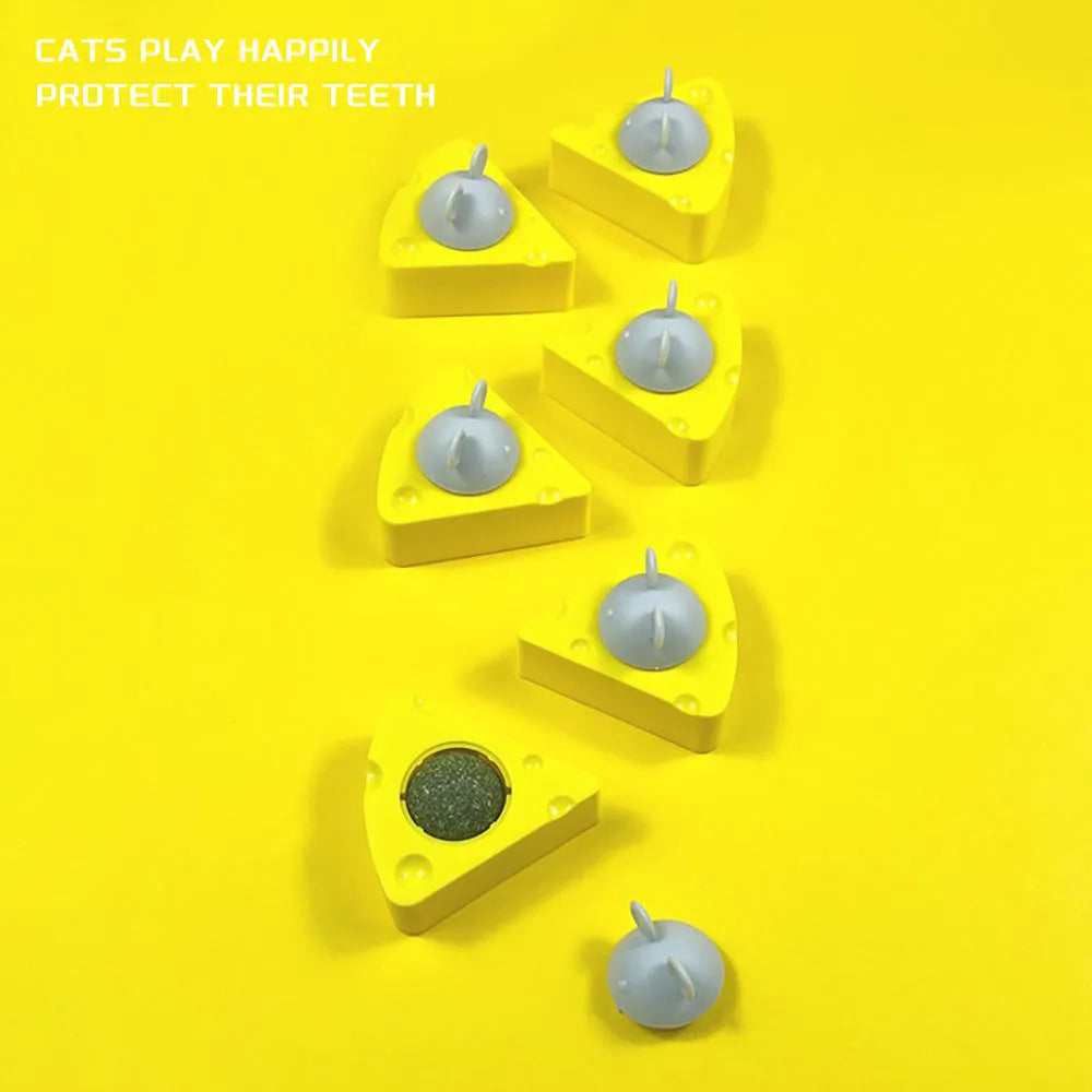 Yellow natural catnip and silvervine chew toy balls for cats on a plain background.