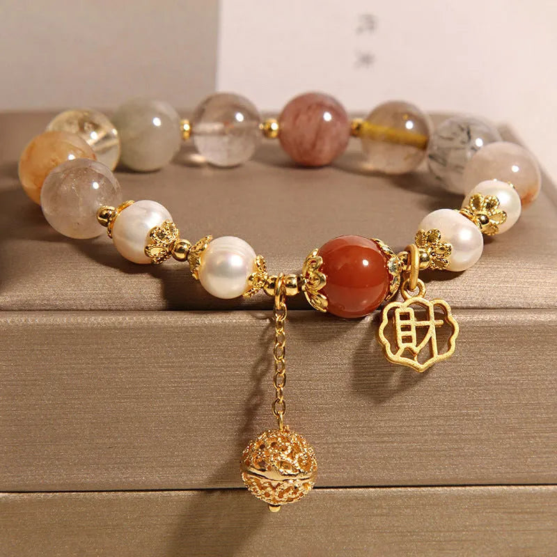 Women's crystal bracelet with colourful hair crystal beads, four pearls, and a Chinese Cai charm.