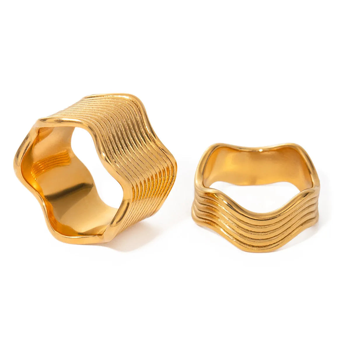 Stainless steel women's ring with a wide geometric wave pattern design on a hand.