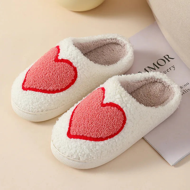 Women's cartoon love style plush slippers in blue smiley colour with round toe and non-slip sole.